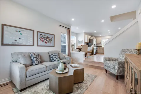 a living room with furniture and view of kitchen