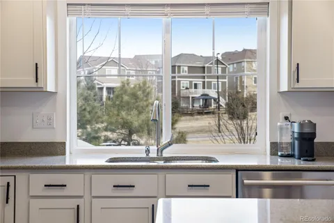 a kitchen with a sink and a large window