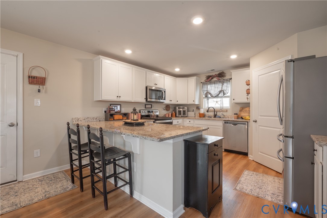17854 Meriwether Lewis Street Ruther Glen, VA 22546 - Photo 14 of 39 Kitchen featuring a peninsula with granite-finish