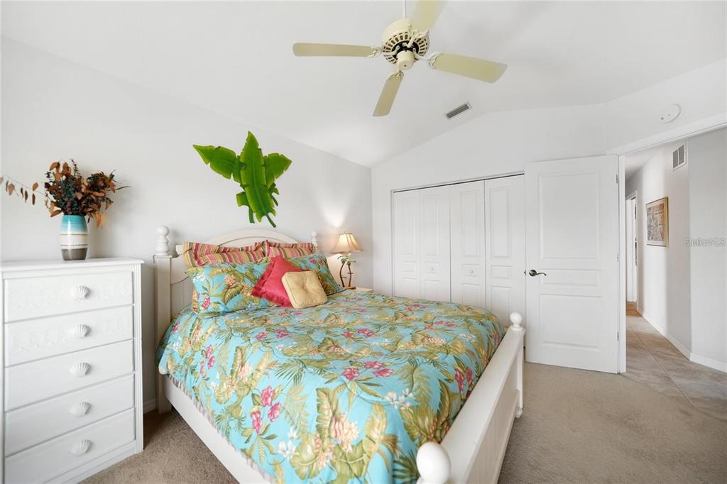 822 Vía Formia Punta Gorda, FL 33950 - Photo 17 of 33 a bedroom with a bed and a potted plant