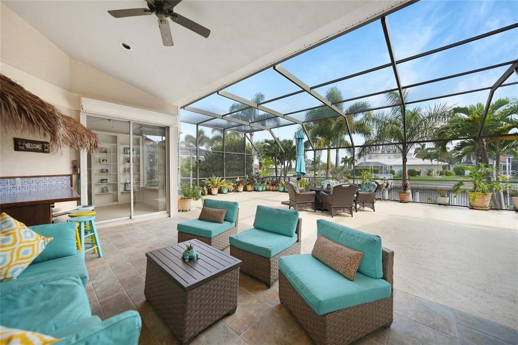 822 Vía Formia Punta Gorda, FL 33950 - Photo 22 of 33 a living room with furniture and a floor to ceiling window