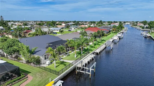 an aerial view of a house with a yard