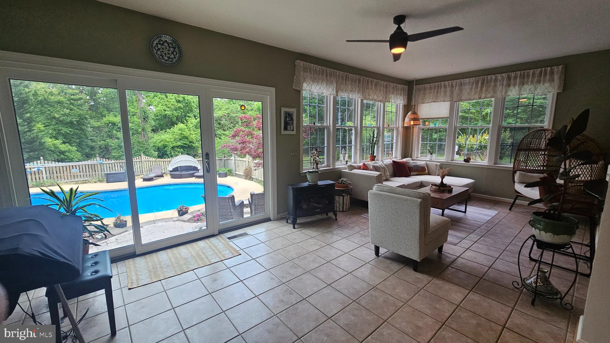 6107 Traceys Overlook Road Tracys Landing, MD 20779 - Photo 9 of 67 a living room with patio furniture and a floor to ceiling window