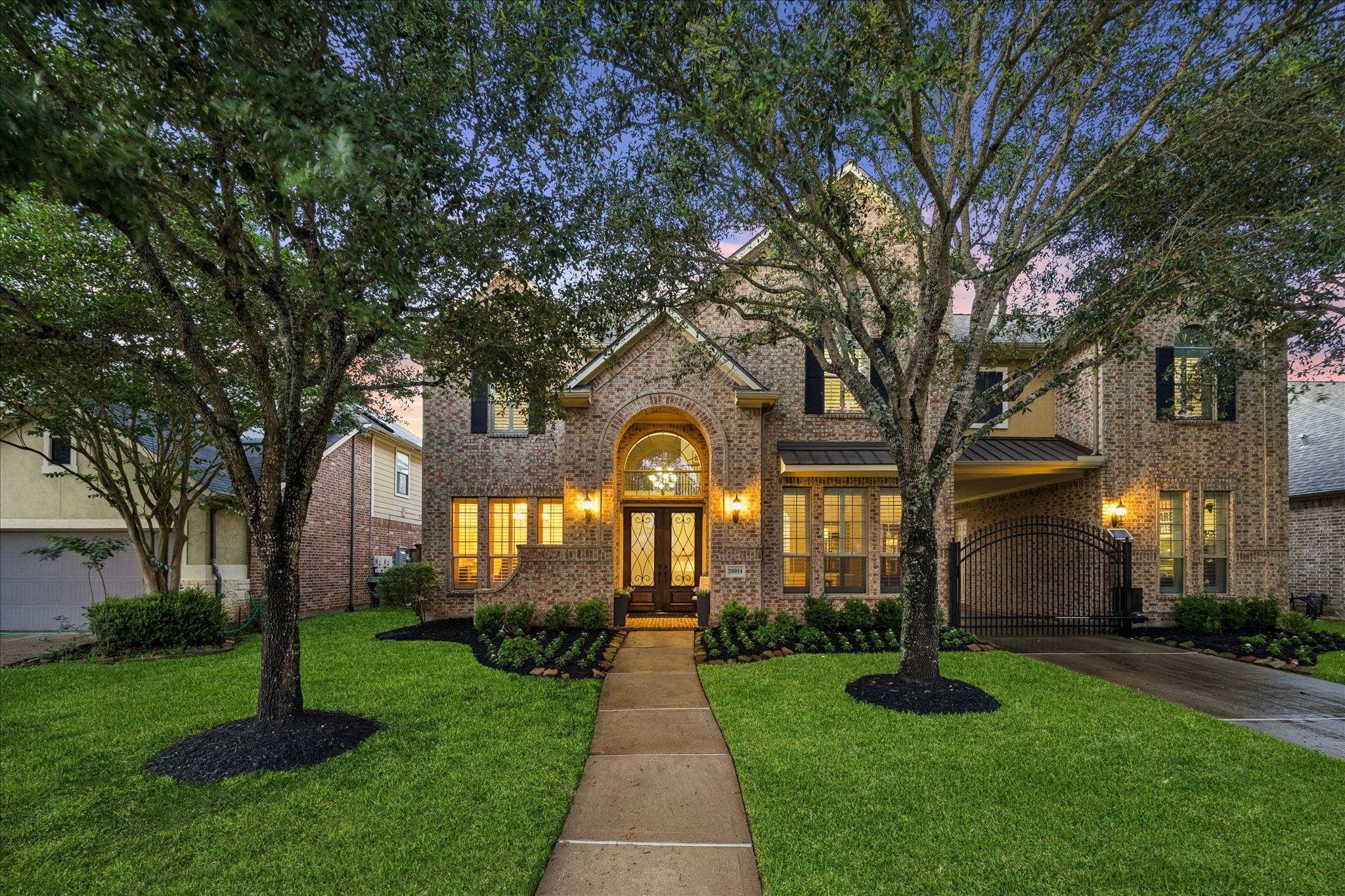 26014 Sebey Ridge Lane Katy, TX 77494 - Photo 8 of 39 Mature trees shade the street, soft light from the windows creates a pretty approach.