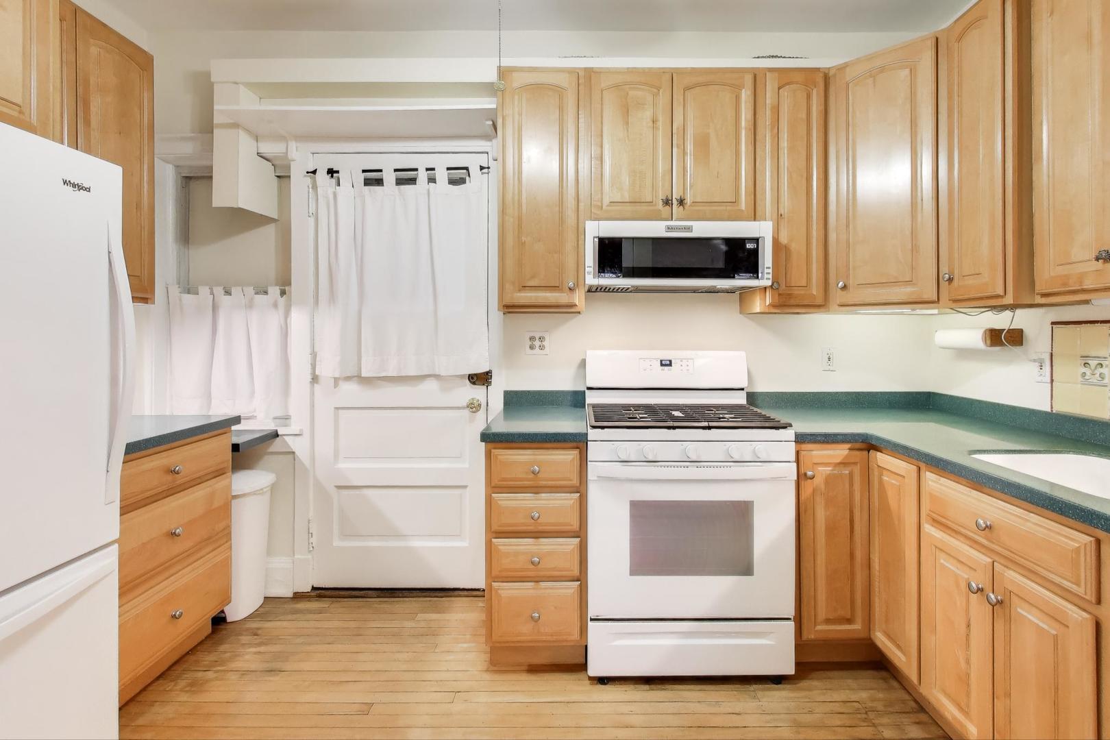 847 Judson Avenue, Unit 2 Evanston, IL 60202 - Photo 11 of 19 a kitchen with granite countertop wood cabinets and stainless steel appliances