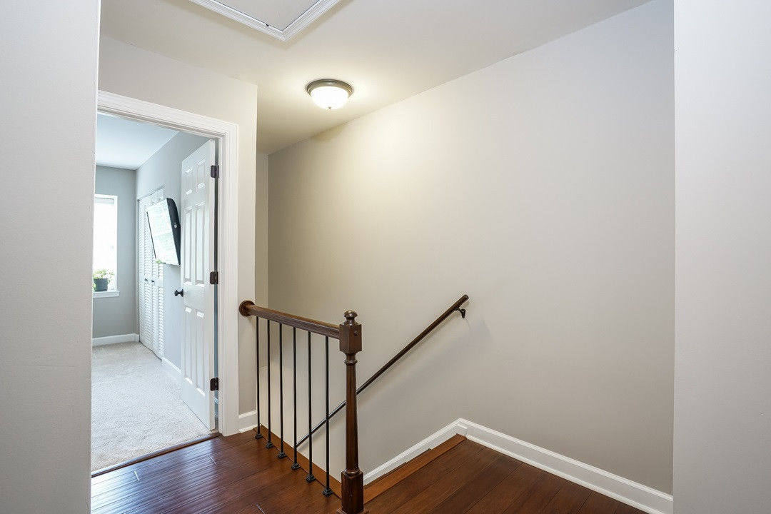 1318 Springlawn Court Raleigh, NC 27609 - Photo 14 of 30 The hardwoods continue in the upstairs landing and hallway. Linen closet. Upstairs Hallway