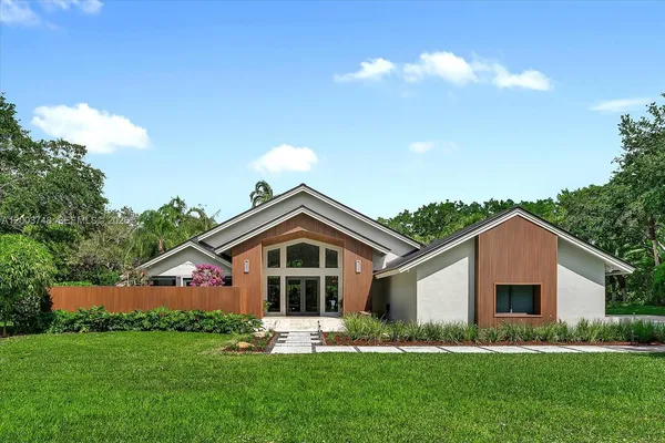 a front view of house with yard and green space