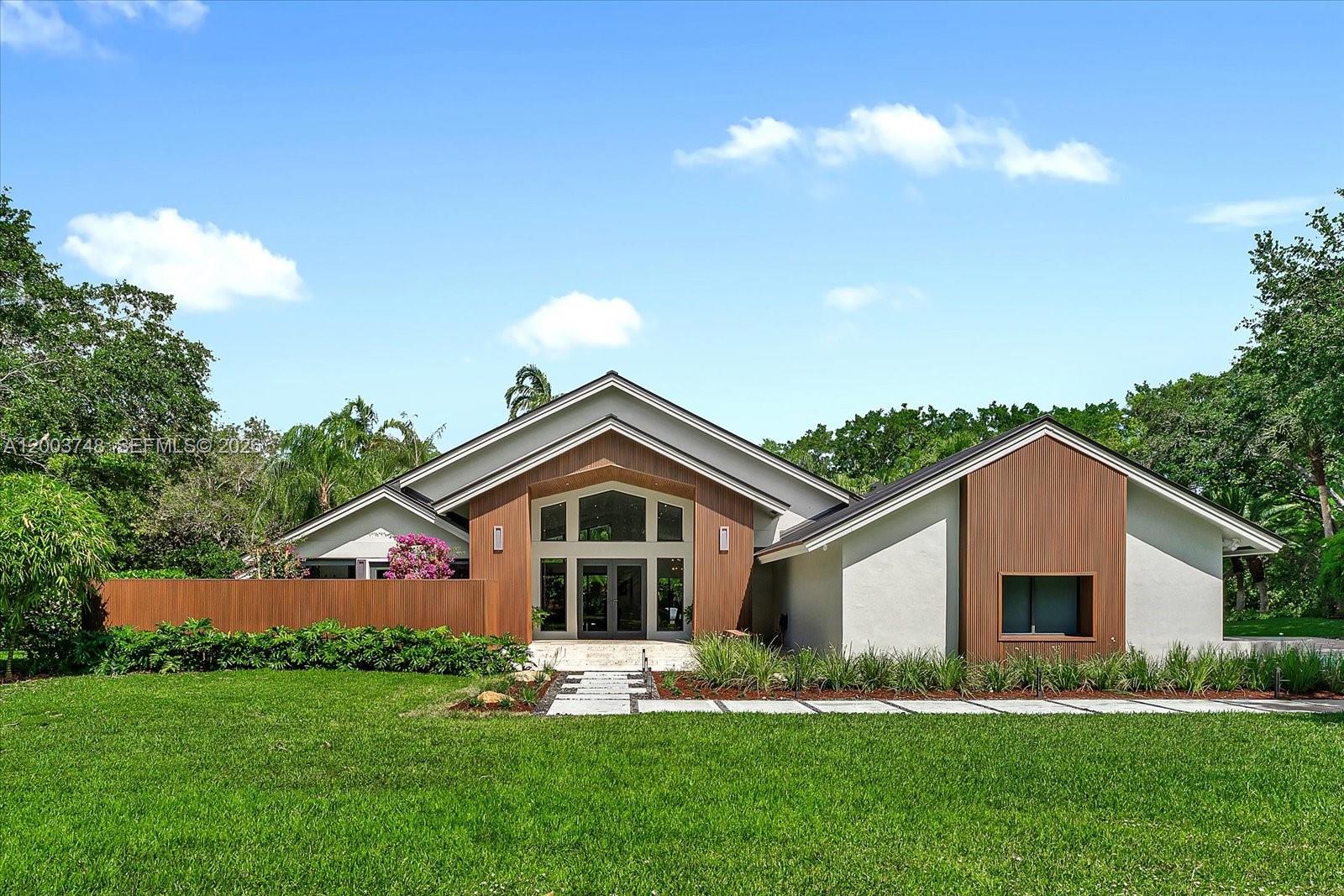 2675 Hackney Road Weston, FL 33331 - Photo 1 of 61 a front view of house with yard and green space