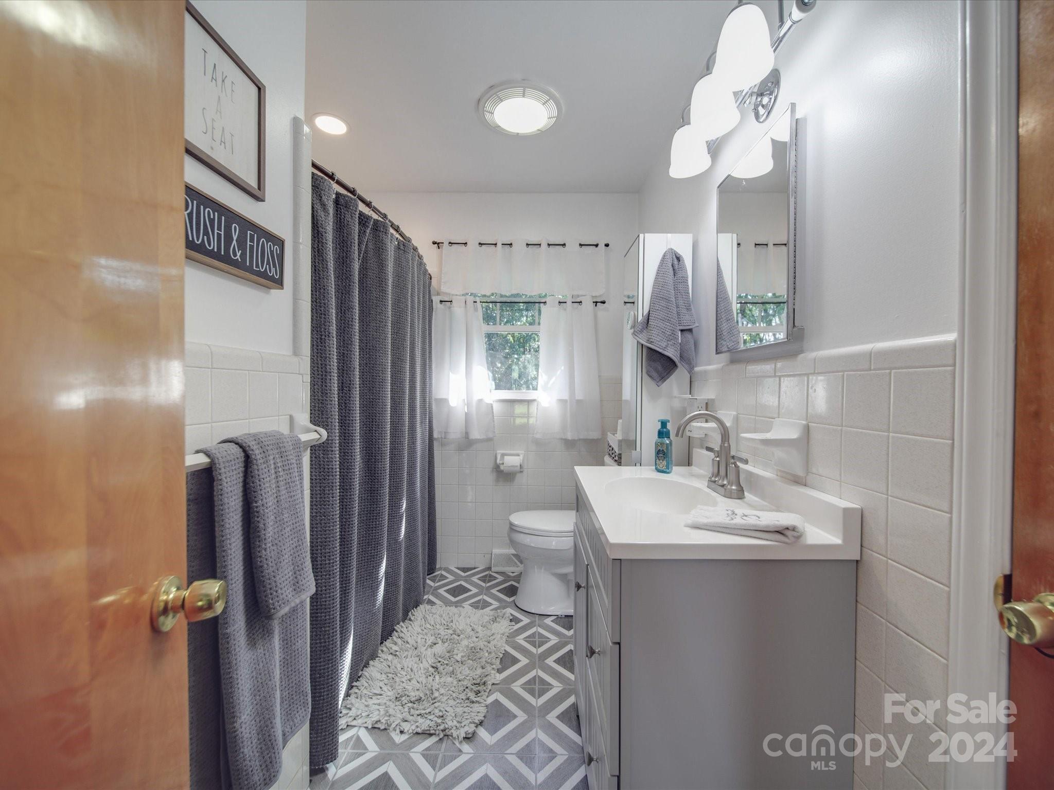 4904 Bud Wilson Road Gastonia, NC 28056 - Photo 32 of 45 a bathroom with a sink a toilet and shower