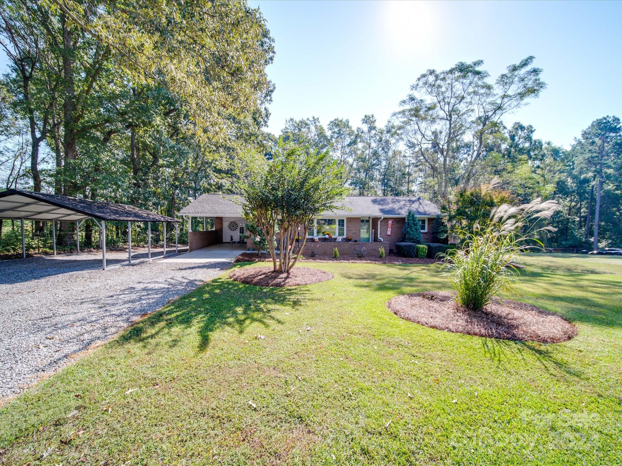 4904 Bud Wilson Road Gastonia, NC 28056 - Photo 5 of 45 a view of house with outdoor space and swimming pool