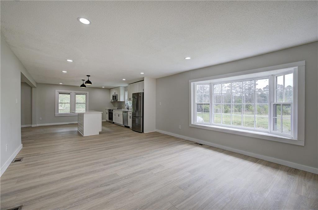 4604 Highway 151 LaFayette, GA 30728 - Photo 15 of 30 a view of an empty room with a window and wooden floor