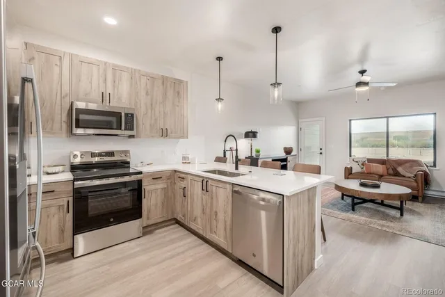 a bathroom with a toilet sink vanity and mirror