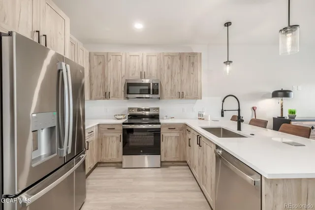 a bed sitting in a bedroom next to a lamp