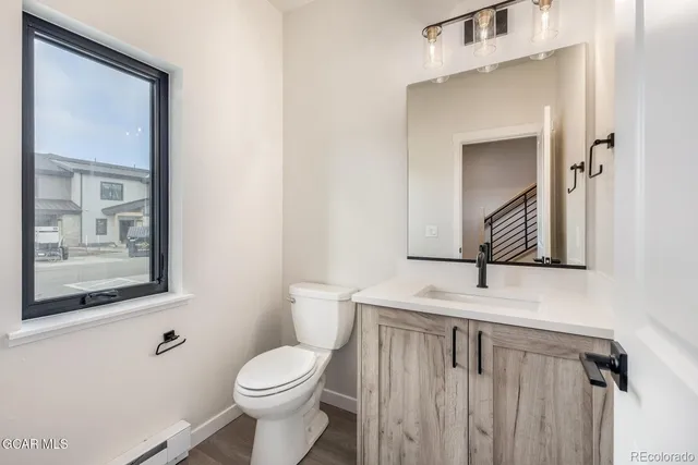 a spacious bedroom with a bed and a chandelier