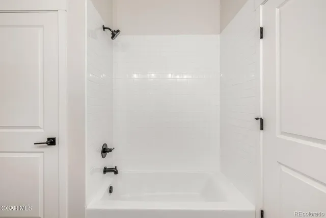 a living room with furniture kitchen view and a chandelier
