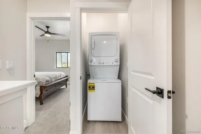 a kitchen with a table a refrigerator a cabinets and wooden floor