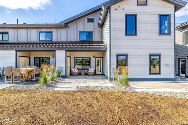 a kitchen with stainless steel appliances a sink a stove a refrigerator and island