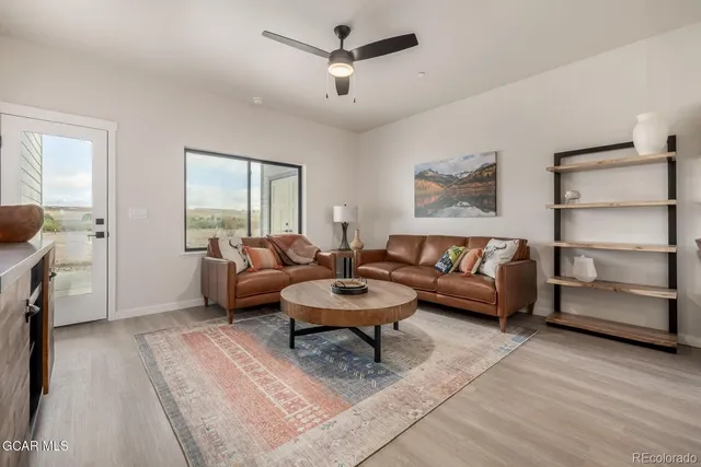 a kitchen with granite countertop a dining table chairs and white cabinets