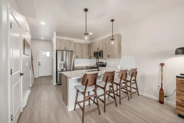 a kitchen with stainless steel appliances a refrigerator sink and microwave