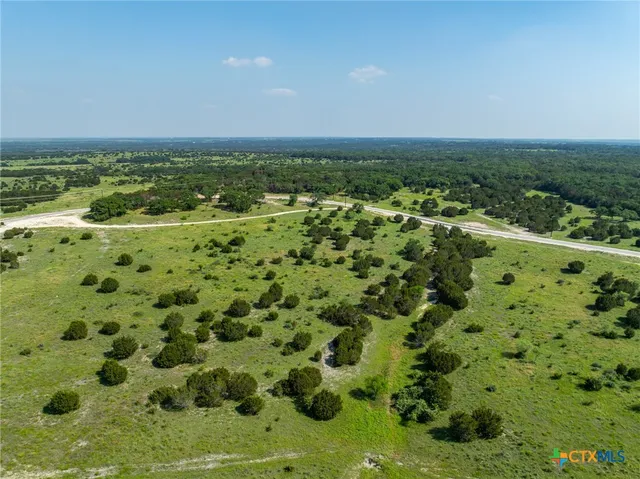 an aerial view of a houses with a yard