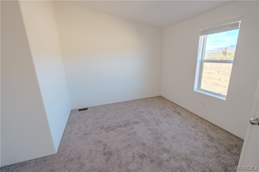 5746 Eden Road Golden Valley, AZ 86413 - Photo 19 of 27 an empty room with a window
