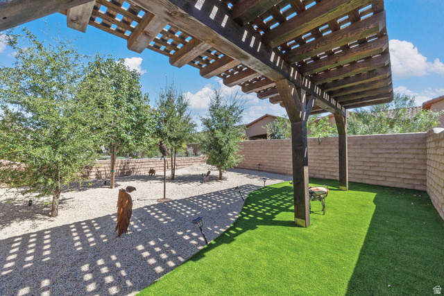 168 South Rancho Santa Fe Virgin, UT 84779 - Photo 55 of 68 Wooden pergola with slat roof, artificial turf, gravel ground cover, and mature trees