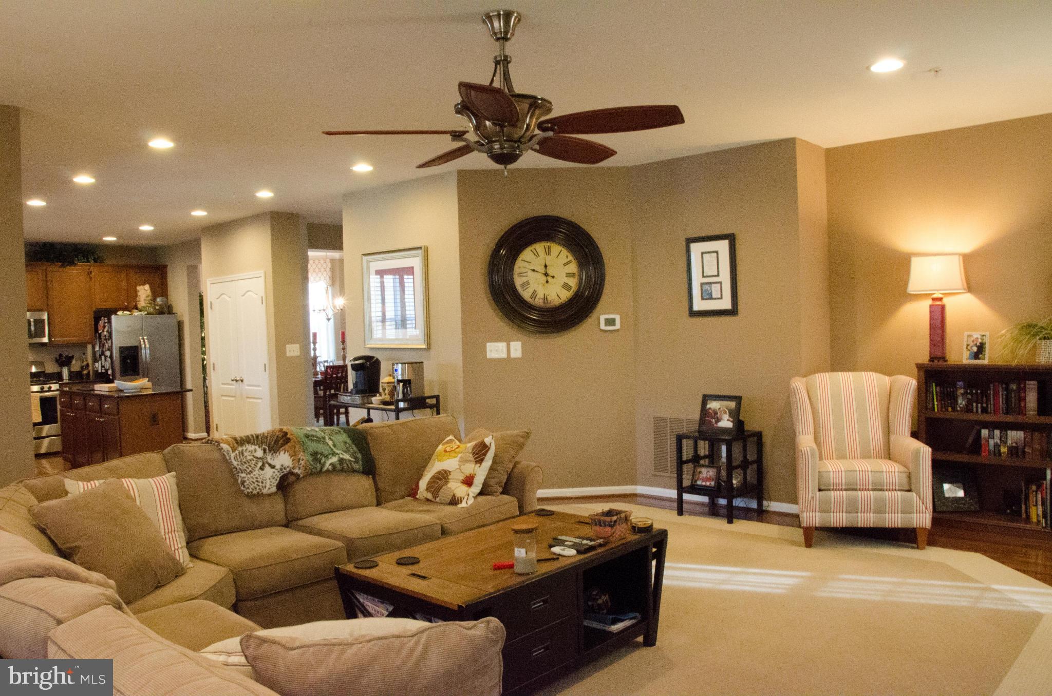 826 Salvatore Road Baltimore, MD 21220 - Photo 8 of 30 a living room with furniture a clock and a ceiling fan