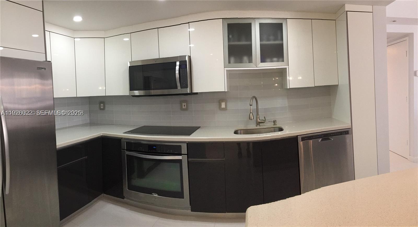 a kitchen with a sink and cabinets