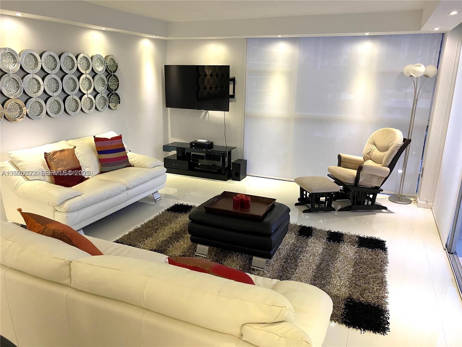 3731 North Country Club Drive, Unit 623 Aventura, FL 33180 - Photo 12 of 30 a living room with furniture and a flat screen tv