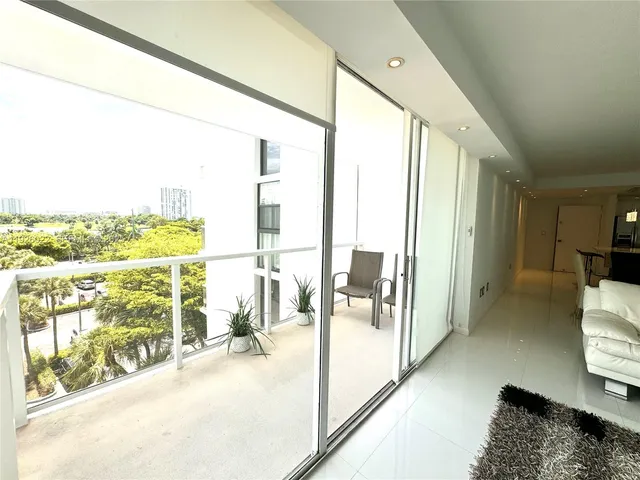 a view of living room with furniture and floor to ceiling window