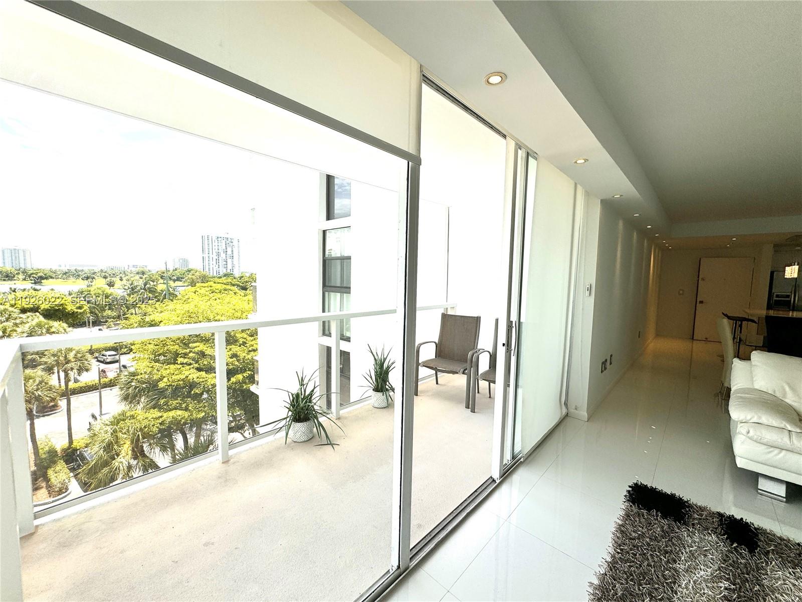3731 North Country Club Drive, Unit 623 Aventura, FL 33180 - Photo 16 of 30 a view of living room with furniture and floor to ceiling window