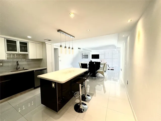 a kitchen with a sink cabinets and wooden floor