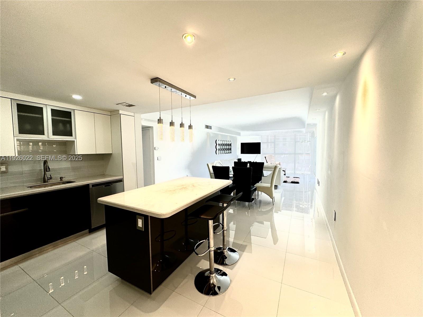 3731 North Country Club Drive, Unit 623 Aventura, FL 33180 - Photo 2 of 30 a kitchen with a sink cabinets and wooden floor