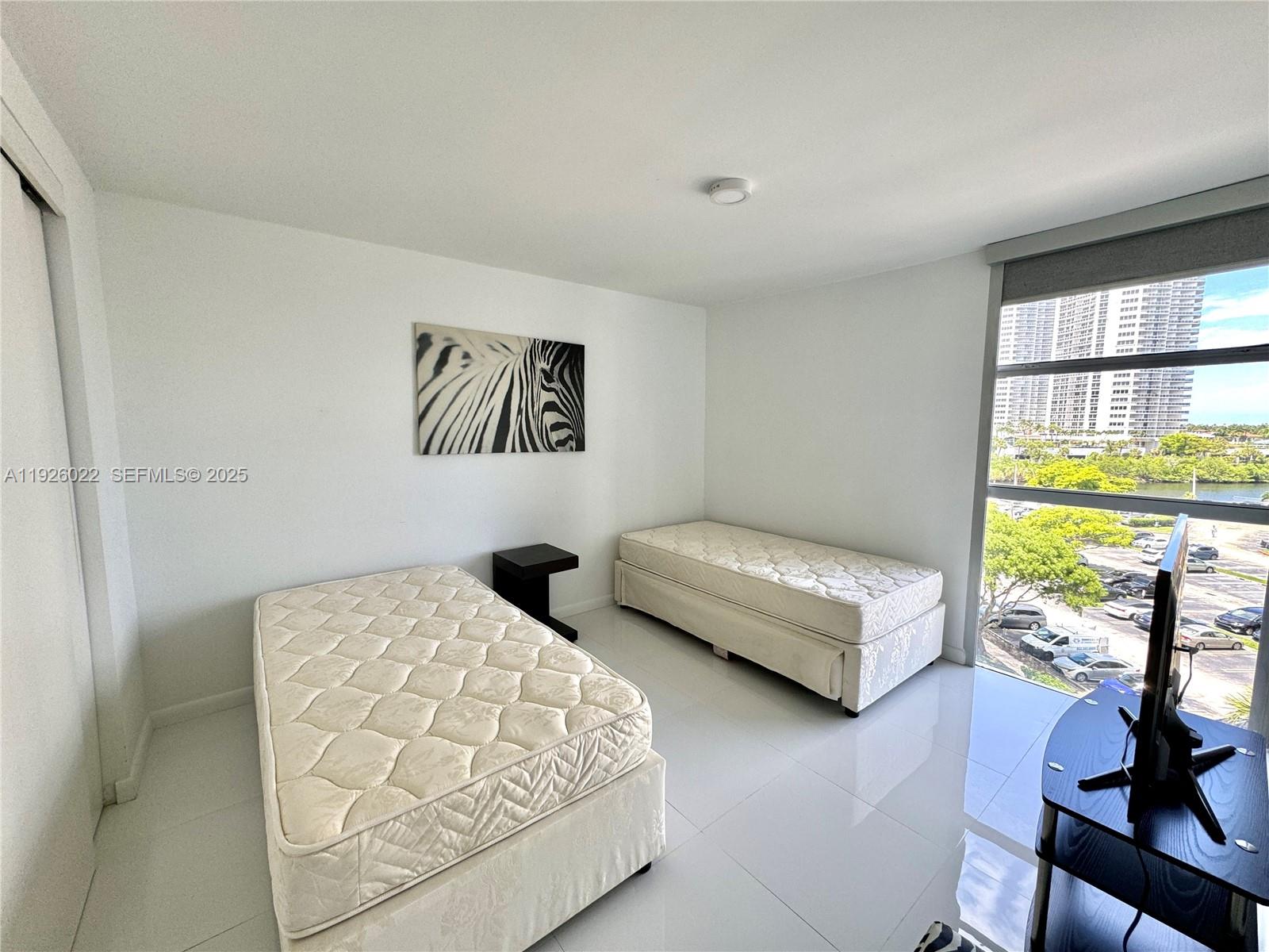 3731 North Country Club Drive, Unit 623 Aventura, FL 33180 - Photo 21 of 30 a bedroom with furniture and a large window