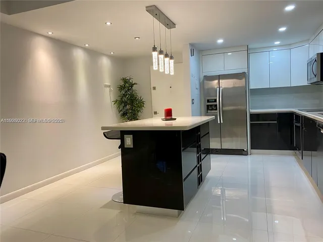 a kitchen with refrigerator and cabinets