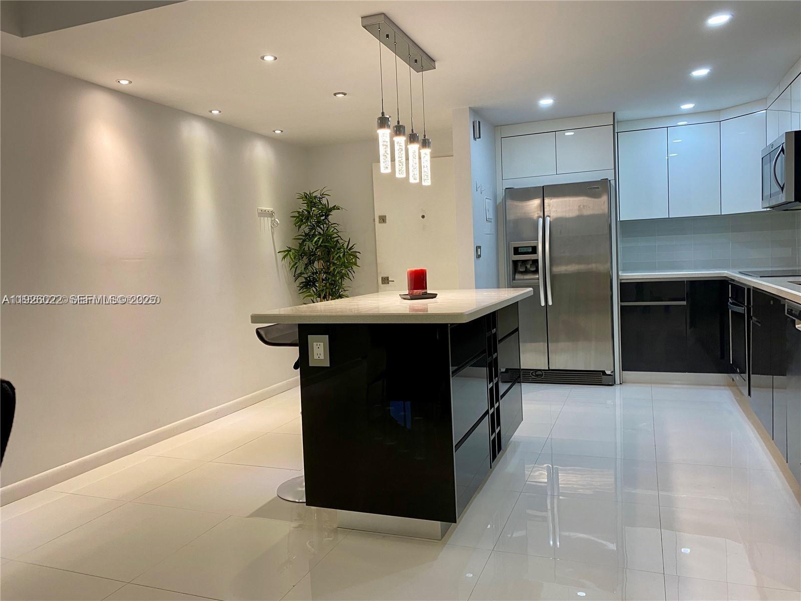 3731 North Country Club Drive, Unit 623 Aventura, FL 33180 - Photo 5 of 30 a kitchen with refrigerator and cabinets