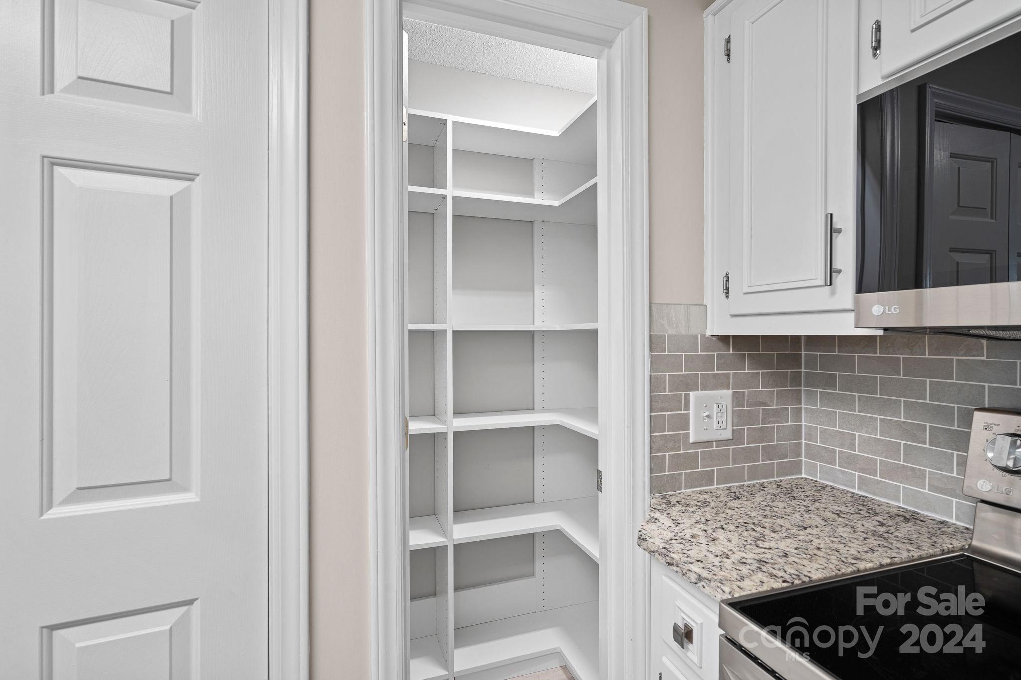 7505 Sarah Drive Denver, NC 28037 - Photo 11 of 34 a kitchen with white cabinets and appliances