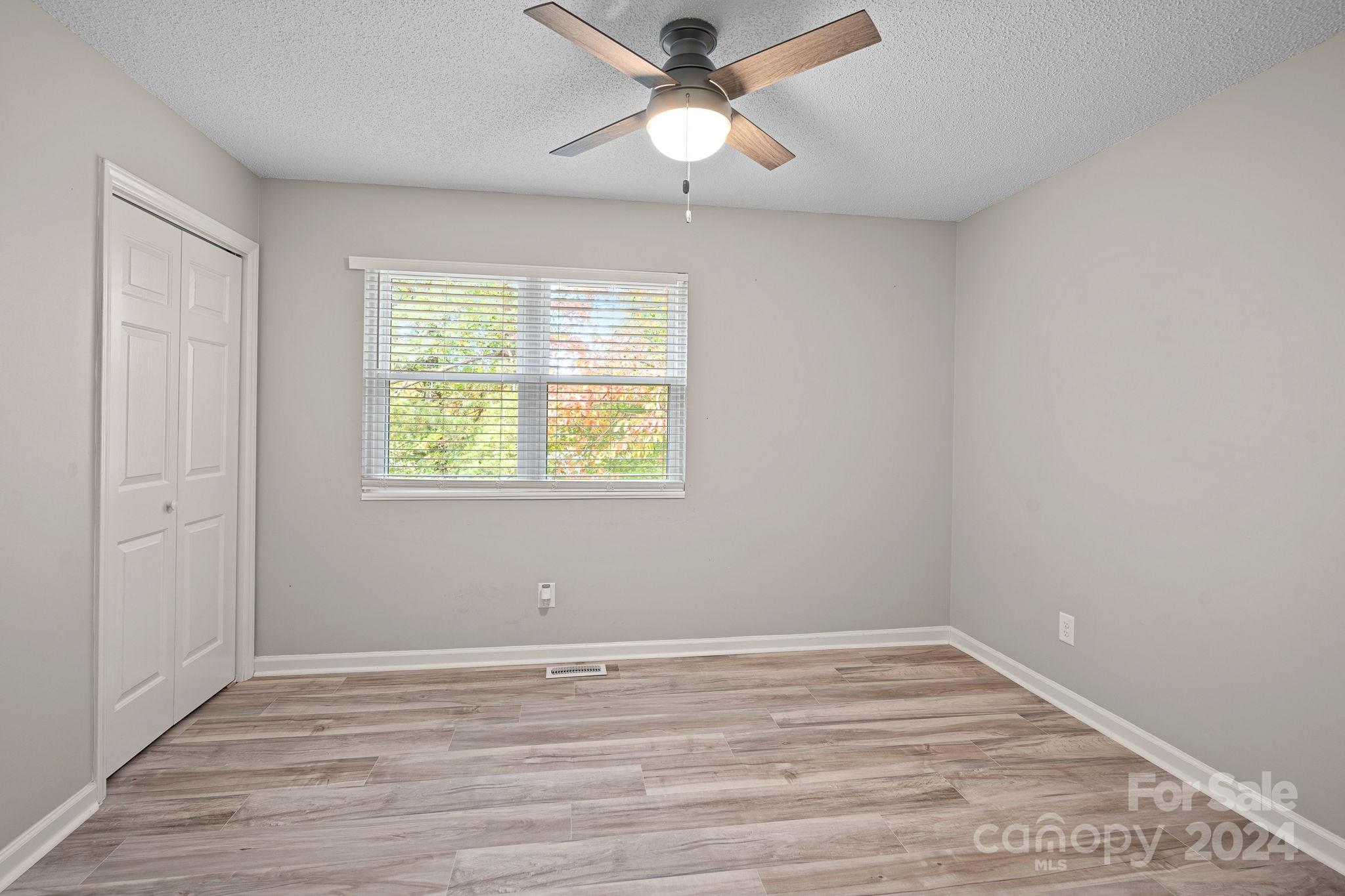 7505 Sarah Drive Denver, NC 28037 - Photo 14 of 34 wooden floor in an empty room with a window