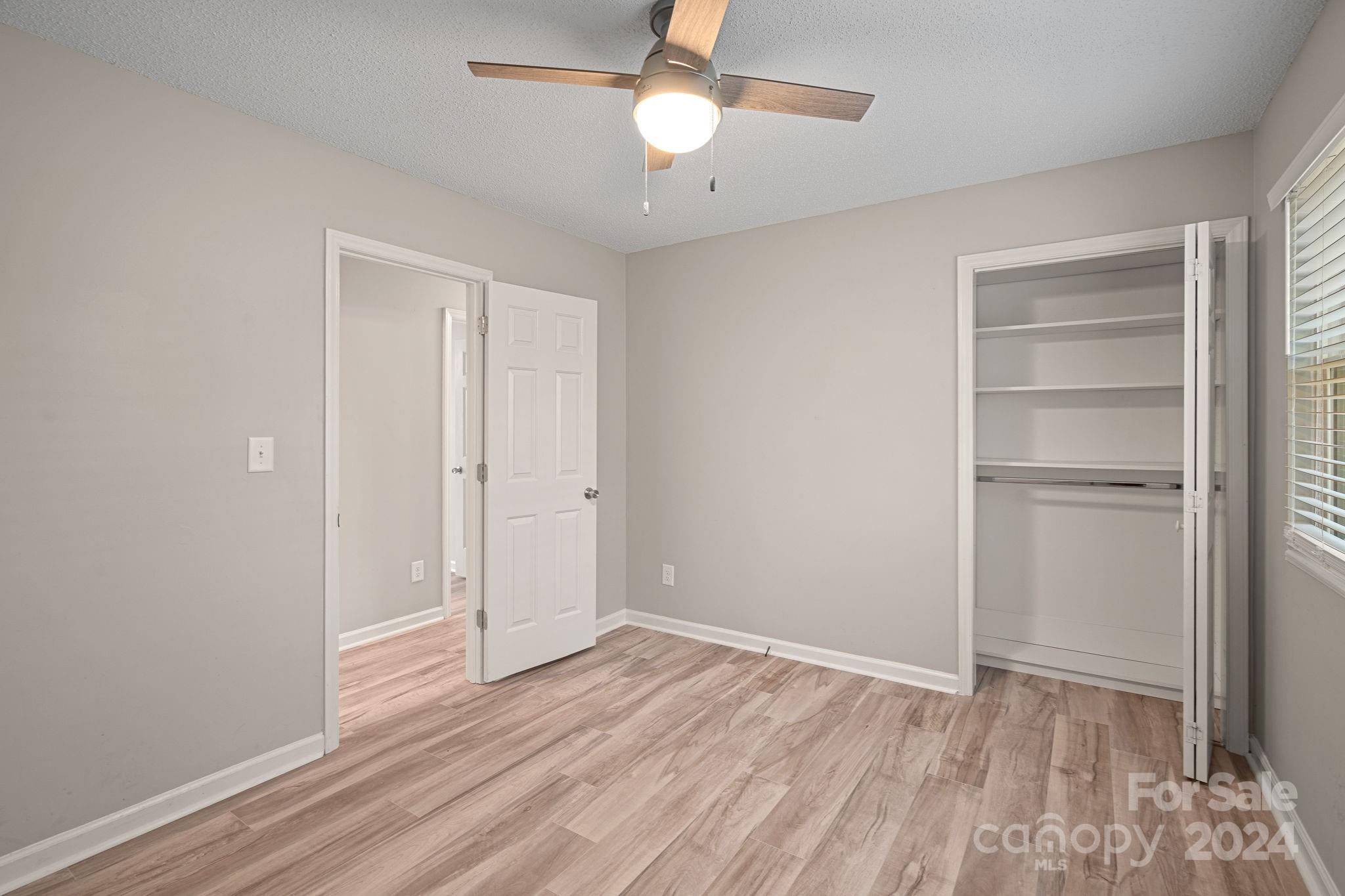 7505 Sarah Drive Denver, NC 28037 - Photo 15 of 34 a view of an empty room with a window and wooden floor