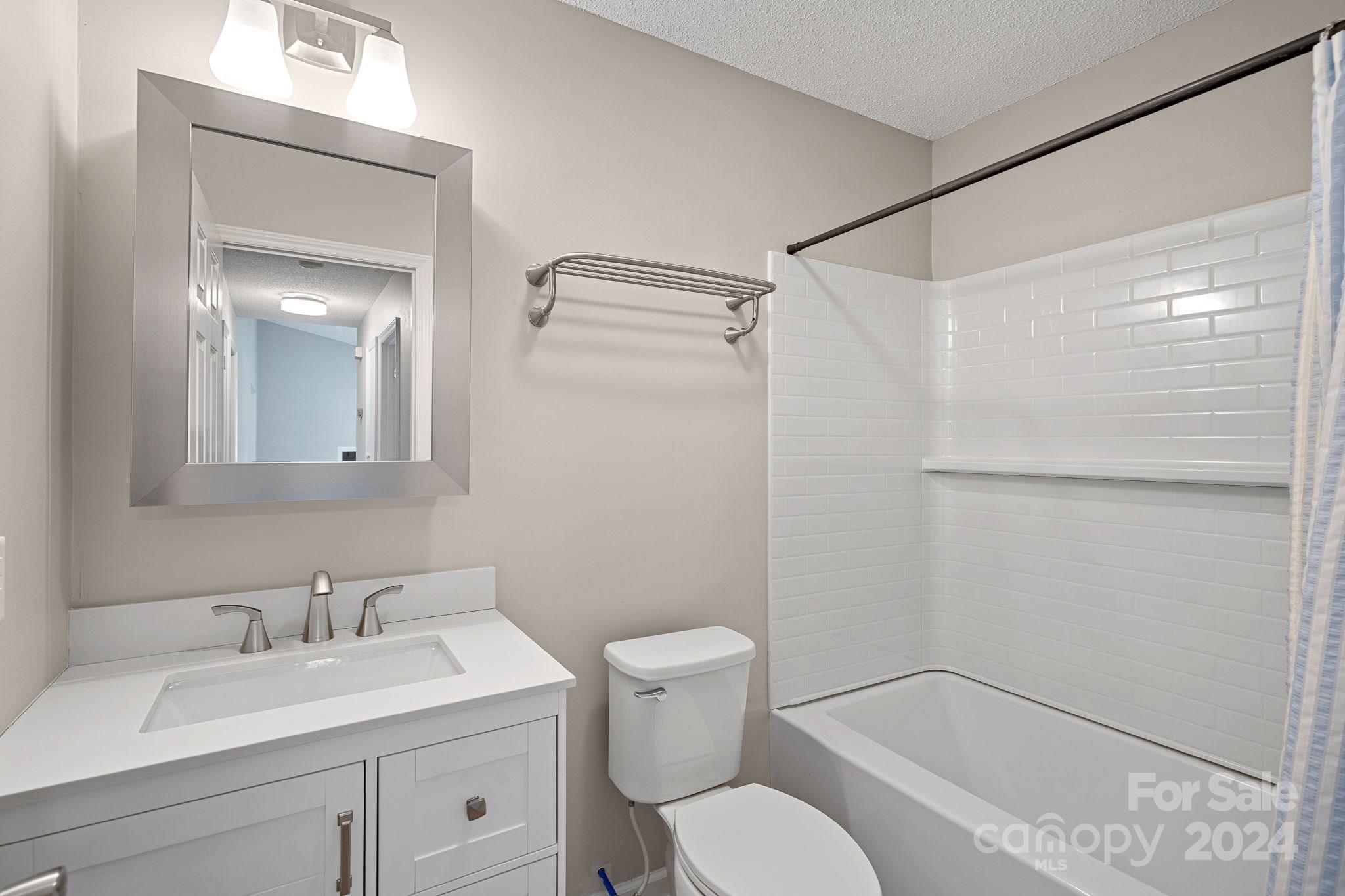 7505 Sarah Drive Denver, NC 28037 - Photo 16 of 34 a bathroom with a granite countertop sink mirror vanity and toilet