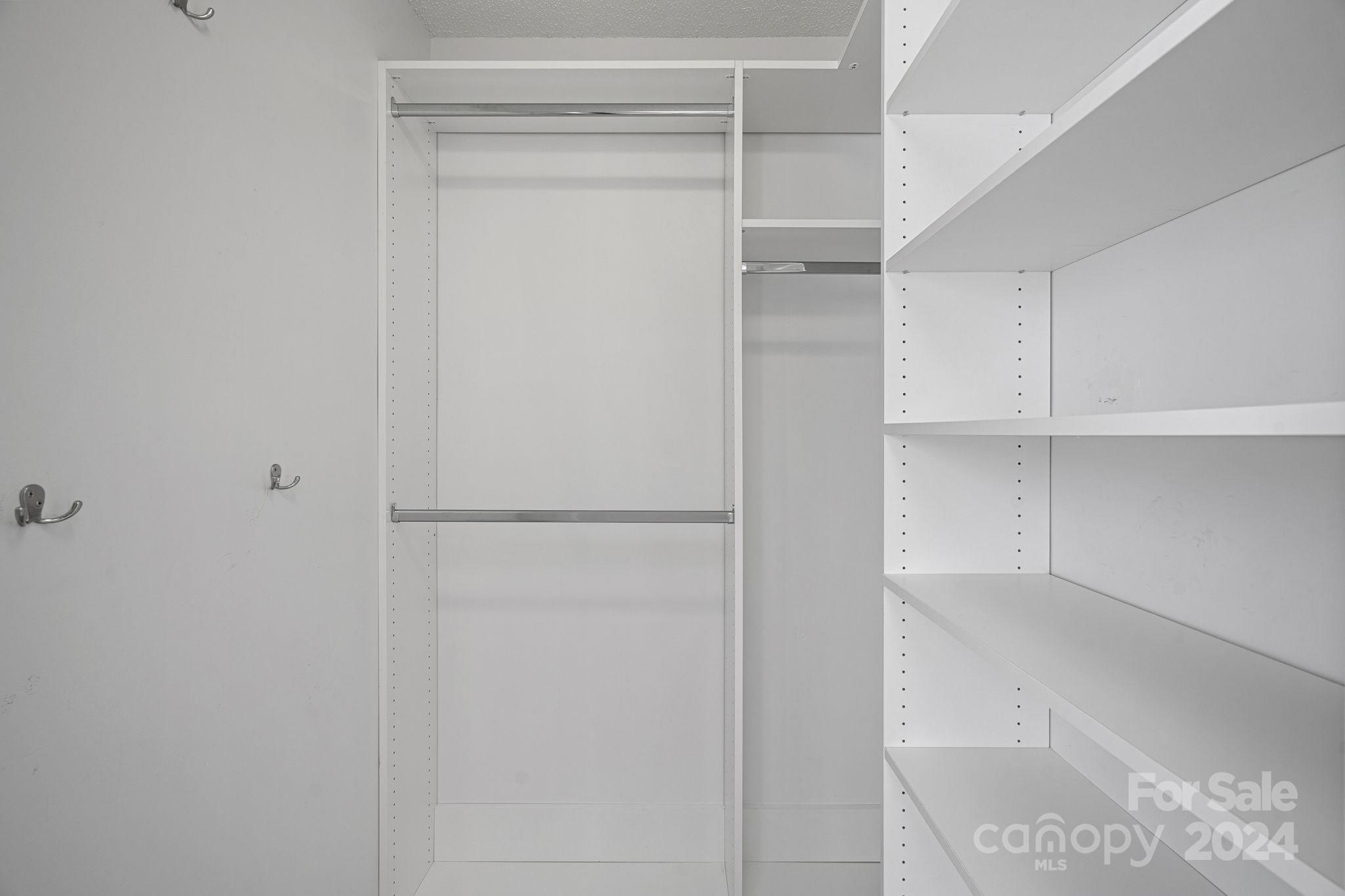 7505 Sarah Drive Denver, NC 28037 - Photo 19 of 34 a view of walk in closet with empty racks