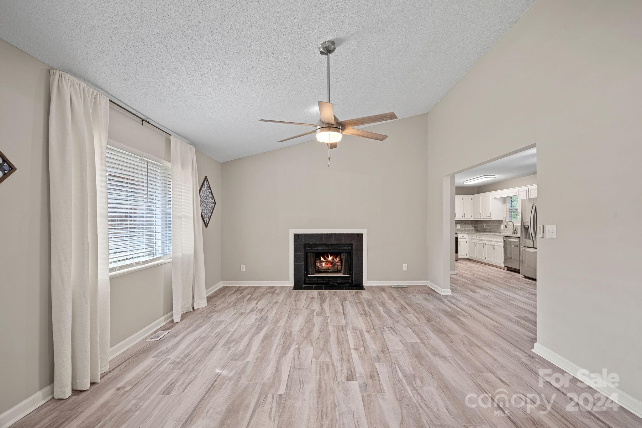 7505 Sarah Drive Denver, NC 28037 - Photo 2 of 34 a view of a livingroom with wooden floor a ceiling fan and a window