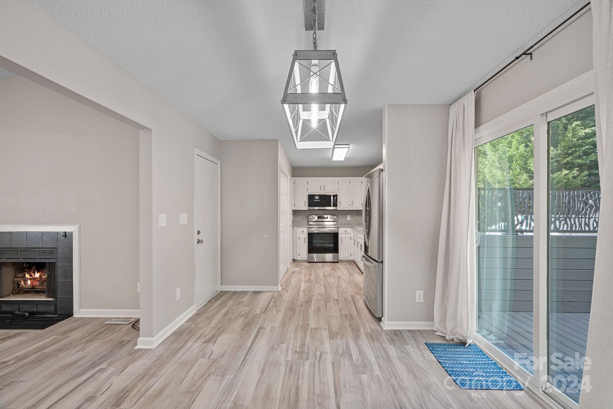 7505 Sarah Drive Denver, NC 28037 - Photo 5 of 34 a view of a room with wooden floor fireplace and windows