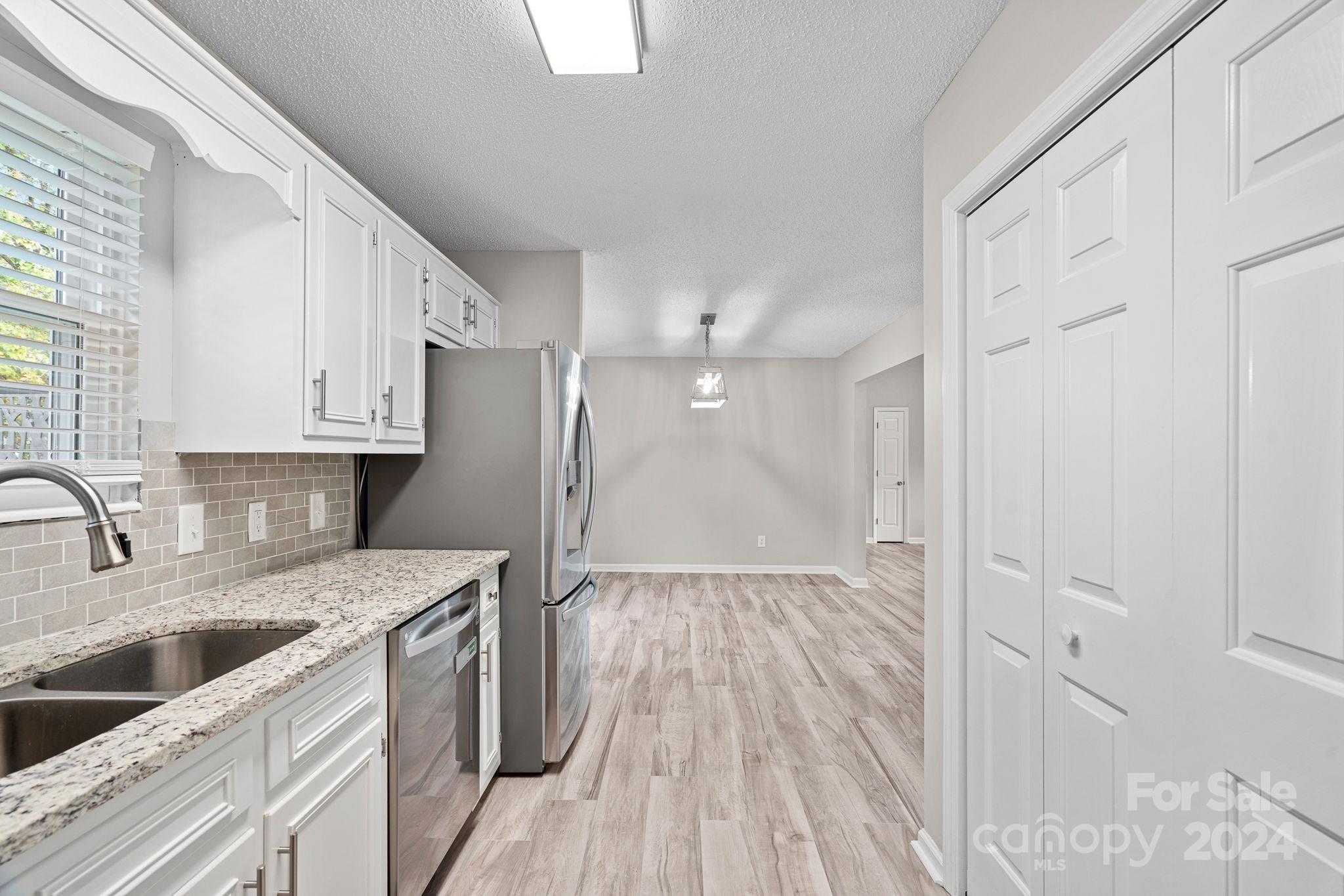 7505 Sarah Drive Denver, NC 28037 - Photo 9 of 34 a kitchen with a sink a refrigerator a stove and cabinets