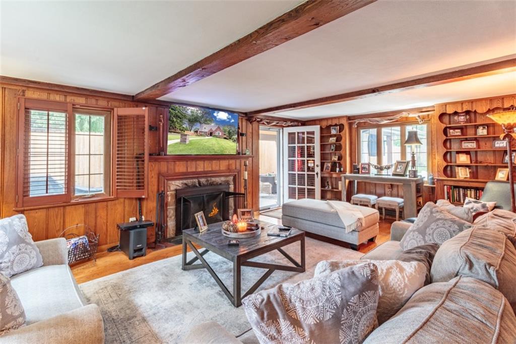 3239 Comanche Road Pittsburgh, PA 15241 - Photo 3 of 25 a living room with furniture a fireplace and floor to ceiling windows