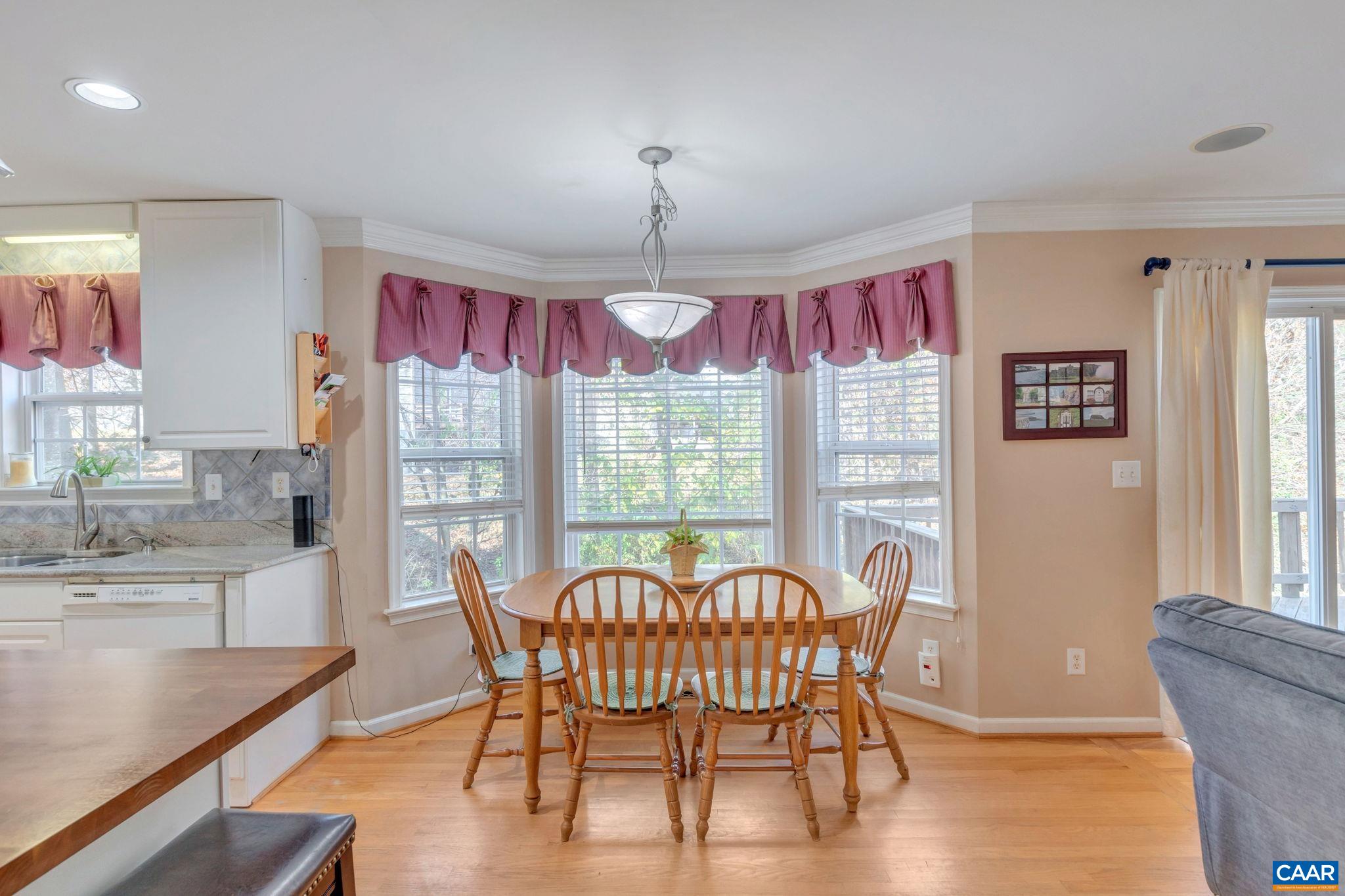 1642 Old Brook Road Charlottesville, VA 22901 - Photo 14 of 42 a dining room with furniture a chandelier and wooden floor