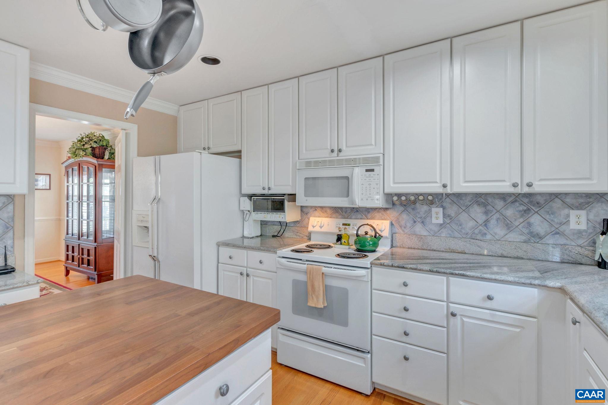1642 Old Brook Road Charlottesville, VA 22901 - Photo 10 of 42 a kitchen with stainless steel appliances white cabinets and wooden floors
