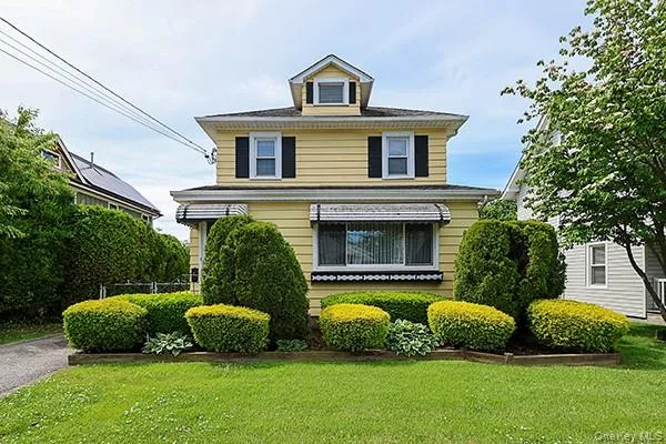 a view of a house with a yard and a garden