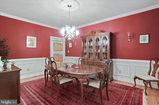 a view of a dining room with furniture and chandelier
