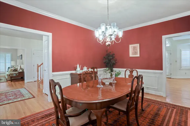 a view of a dining room with furniture wooden floor and chandelier